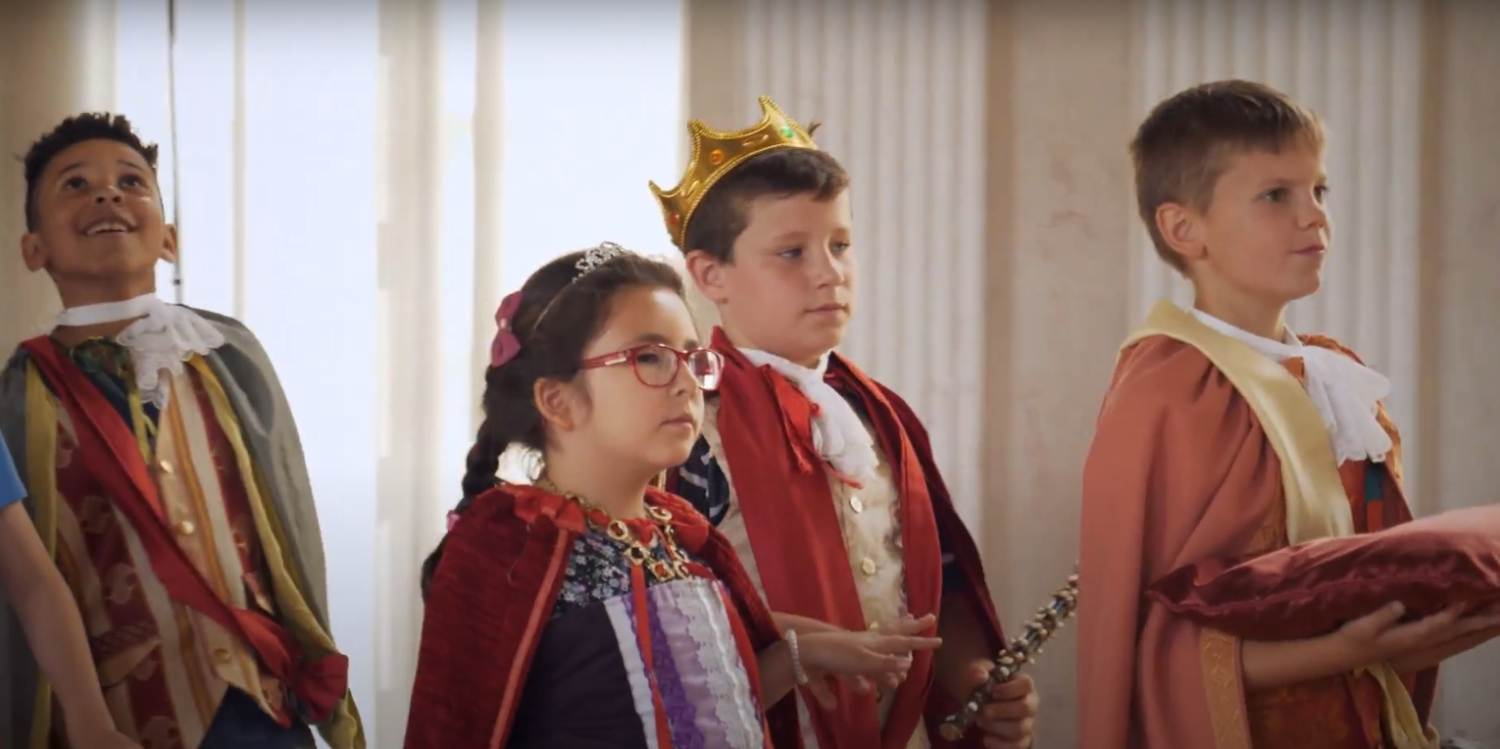 Drei Jungen und ein Mädchen in Kostümen.